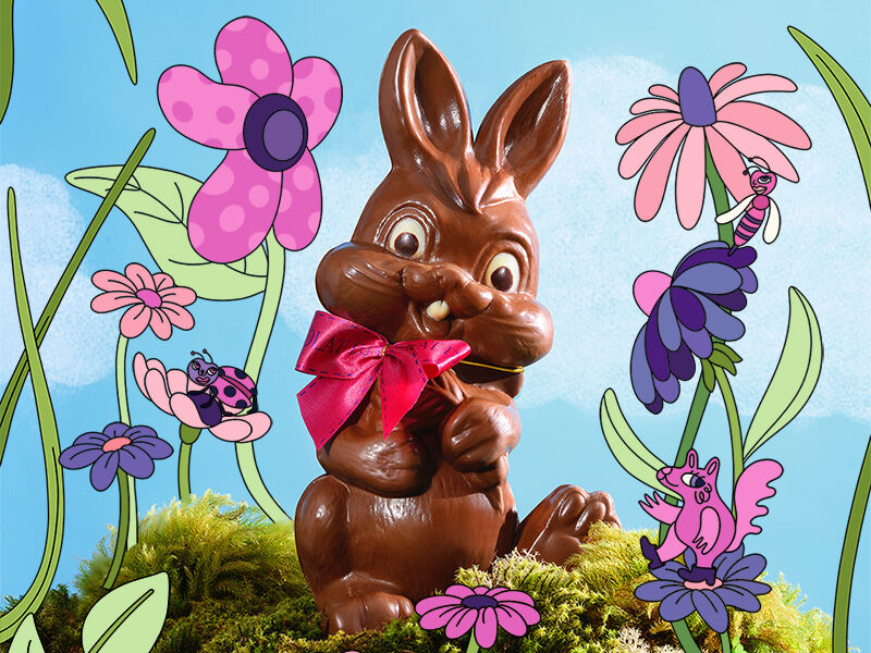 Coelho de chocolate em fundo floral colorido